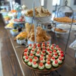 A buffet of appetizers on a wooden table.