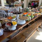 A buffet table with a lot of food on it.