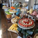 A buffet table with a variety of food on it.