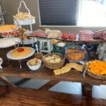 A buffet table with a variety of food on it.