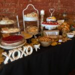 A buffet table with a variety of snacks and desserts.