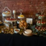 A buffet table with a variety of food on it.