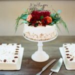 Two wedding cakes on a wooden table.