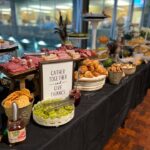 A buffet table with a lot of food on it.