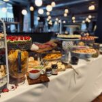 A buffet table with a variety of food on it.