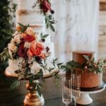 A three Tiered Cakes on a wooden table.