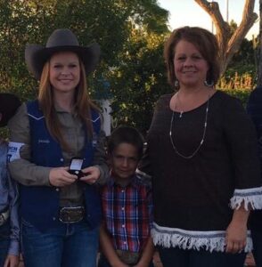 A group of people in cowboy hats posing for a picture.