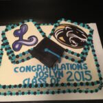 A cake decorated with a graduation cap and diploma.