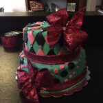 A cake with polka dots and pink bows.