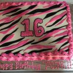 A zebra print birthday cake with the number 16 on it.