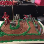 A birthday cake with a dirt bike on it.