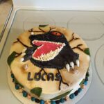 A cake with a dragon on top of it.