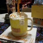 A birthday cake with a beer mug on it.