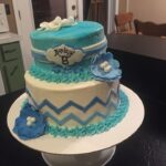 A blue and white chevron cake on top of a table.