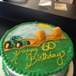 A 60th birthday cake with a tractor on it.