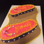 A birthday cake with flip flops on it.