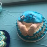 A baby shower cake with a baby's footprint on it.