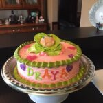 A cake decorated with a baby's face.