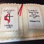 A cake decorated with a bible and a cross.