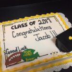 A cake decorated with a graduation cap and hat.