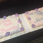 Two cakes with happy birthday written on them.