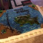 A birthday cake with a fish on it.