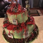 A cake decorated like a graveyard with skeletons and zombies.