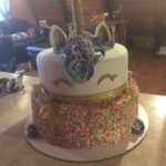 A unicorn cake with sprinkles on top.