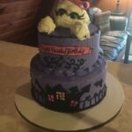 A purple birthday cake with a ghost on it.