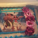 A cake with a picture of moana on it.