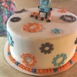 A cake decorated with a robot and gears.