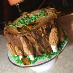 A cake decorated like a tree stump.