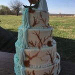 A wedding cake with a deer on it.