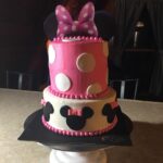 A minnie mouse cake with pink and white polka dots.