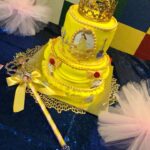 A yellow cake with a tiara on top.