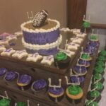 A cake decorated with footballs and cupcakes.