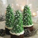 Three christmas trees on a plate with pine cones.