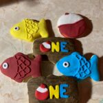 A set of cookies with a fish and a fisherman's hat.