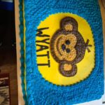 A birthday cake with a monkey on it.