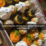 A tray of halloween cupcakes on a table.