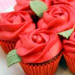 Red rose cupcakes on a white plate.