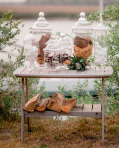 A table with glass jars and marshmallows on it.