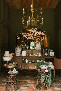 A coffee bar in a barn with a chandelier.