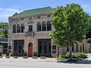 An old building with a red door on the corner.